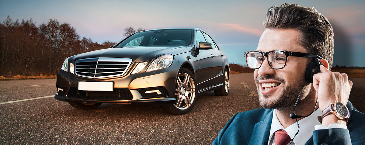 Man answering phone in front of car